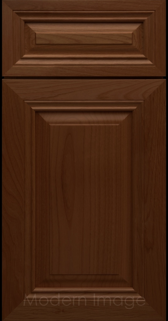 Close-up of a Pecan-stained wood cabinet door with a mitered frame and traditional Cambridge raised center panel.